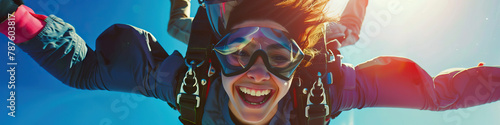 A person with a mobility impairment smiling while skydiving with the assistance of an experienced instructor photo