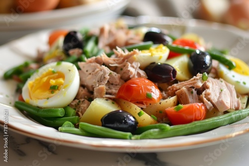 Nicoise salad with tuna green beans tomatoes eggs potatoes olives anchovies and mustard dressing