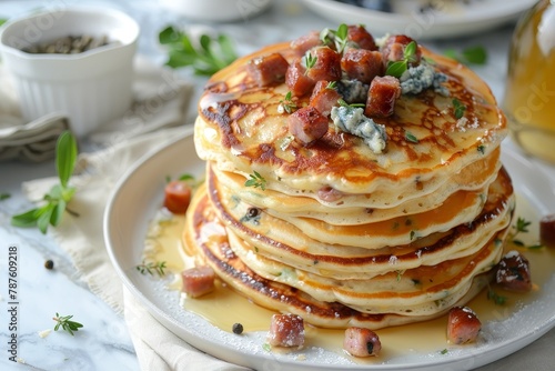 Pancakes with sausage and blue cheese on plate with napkin on marble