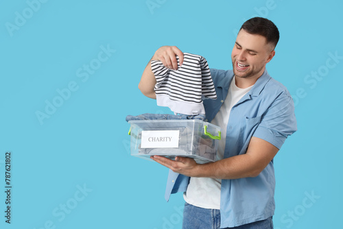 Young man holding box with ...