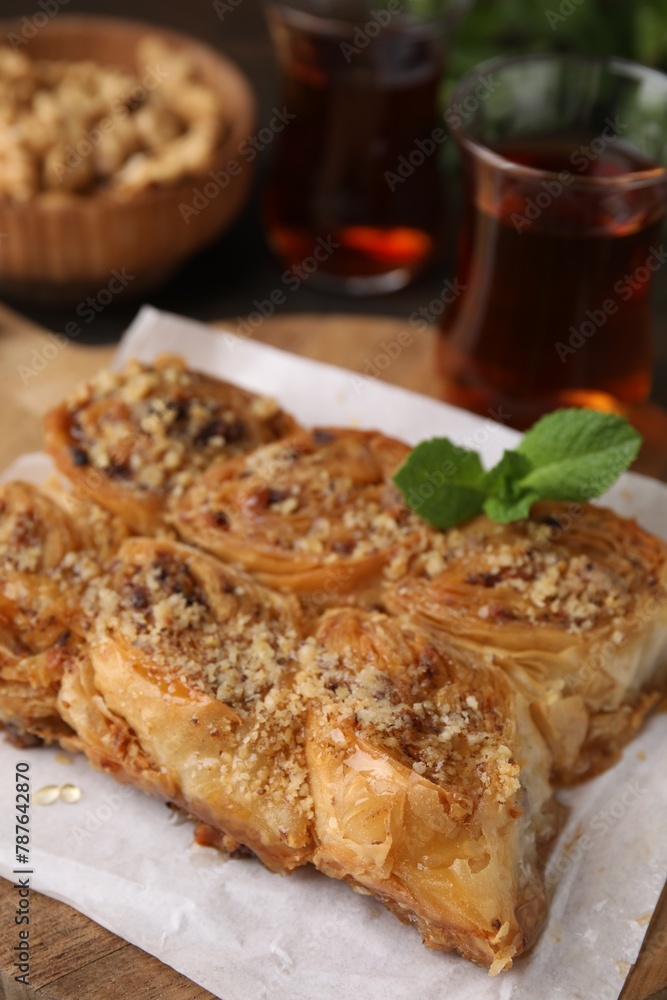 Eastern sweets. Pieces of tasty baklava and tea on table, closeup Eastern sweets. Pieces of tasty baklava and tea on table, closeup