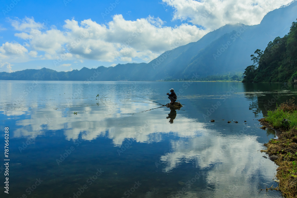 Beautiful Lake Batur landscape overlooking serene and beautiful Mount Batur during blue sky cloudy day Beautiful Lake Batur landscape overlooking serene and beautiful Mount Batur during blue sky cloudy day
