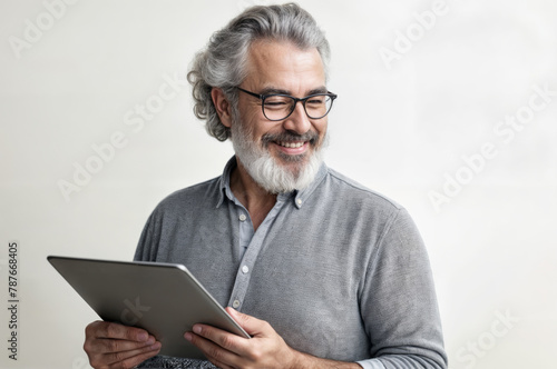 Portrait of happy senior asian man using digital tablet at home