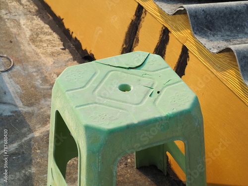 Broken and damaged plastic chair. Abandoned furniture concept.