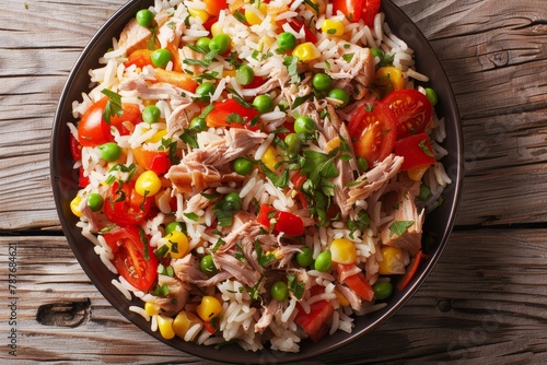 Top view of a rice salad with tuna and vegetables on a plate
