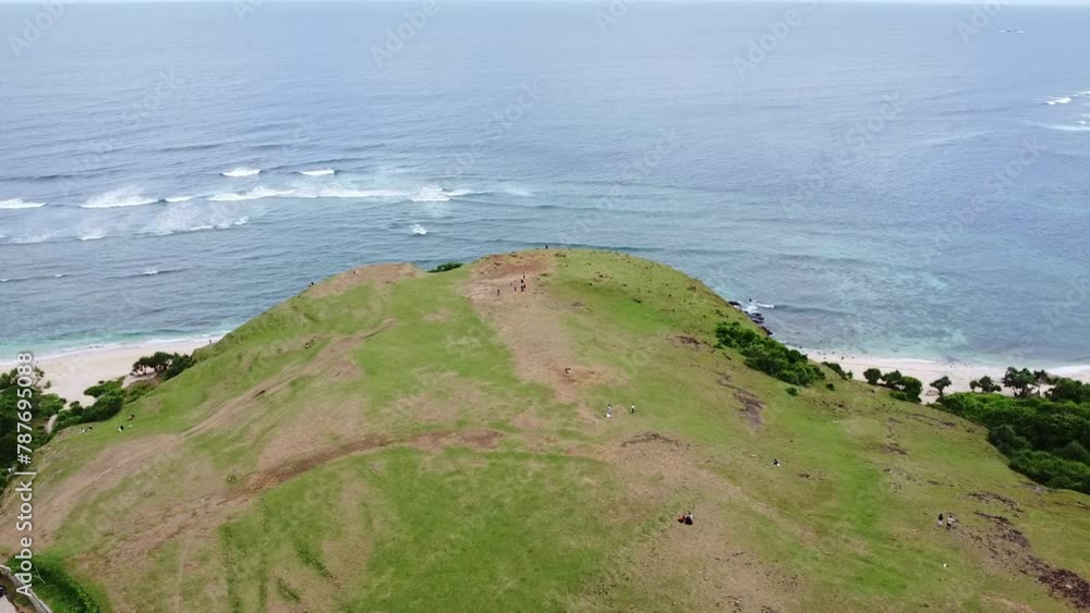 The beautiful Aerial view from the green hillside overlooking the blue sea, Bukit Merese Hill, West Nusa Tenggara, Lombok, Indonesia The beautiful Aerial view from the green hillside overlooking the blue sea, Bukit Merese Hill, West Nusa Tenggara, Lombok, Indonesia