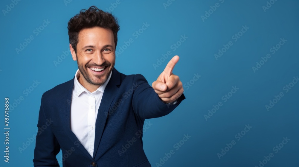 Portrait of cheerful businessman pointing at copy space for advertising against blue background Portrait of cheerful businessman pointing at copy space for advertising against blue background