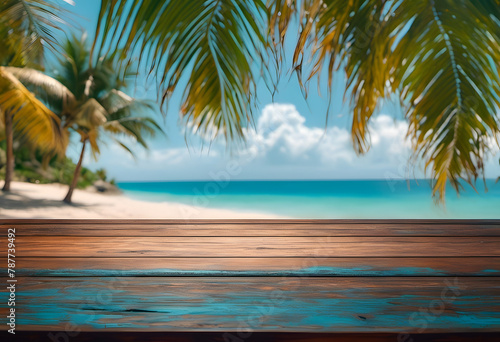 Tropical beach view through palm leaves, focusing on a wooden table with a blurred ocean background. photo