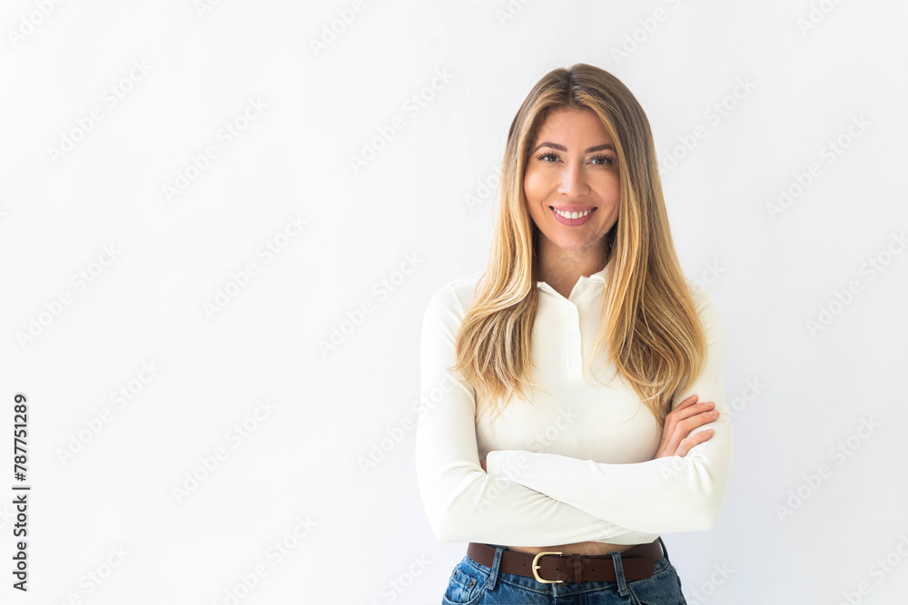 Portrait of a young Caucasian woman with pleasant smile and crossed arms isolated on white wall Portrait of a young Caucasian woman with pleasant smile and crossed arms isolated on white wall