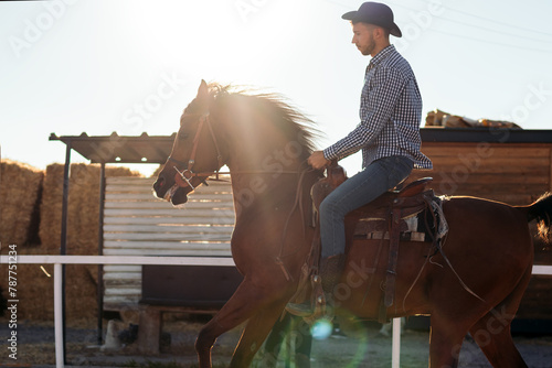 Man riding a horse in an equestrian center © PEDROMERINO