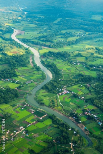 An aerial view of a picturesque countryside, with quaint villages, patchwork farmland, and winding rivers meandering through lush valleys, Generative AI © ManusiaIkan