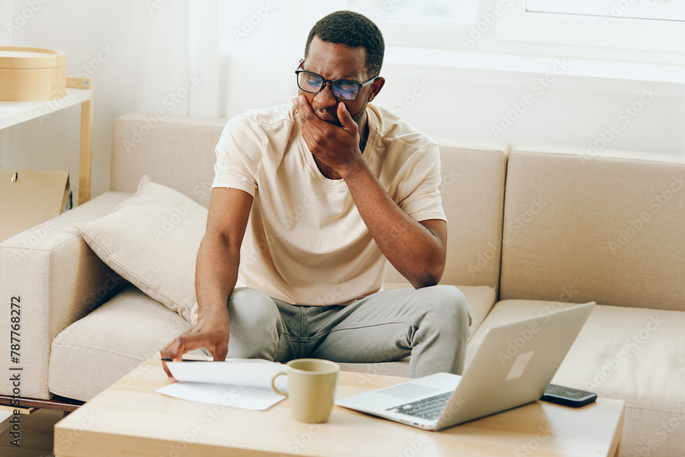 Smiling African American Man Freelancer Working on Laptop in Modern Home Office, Typing Away with a Cyberspace Background Smiling African American Man Freelancer Working on Laptop in Modern Home Office, Typing Away with a Cyberspace Background