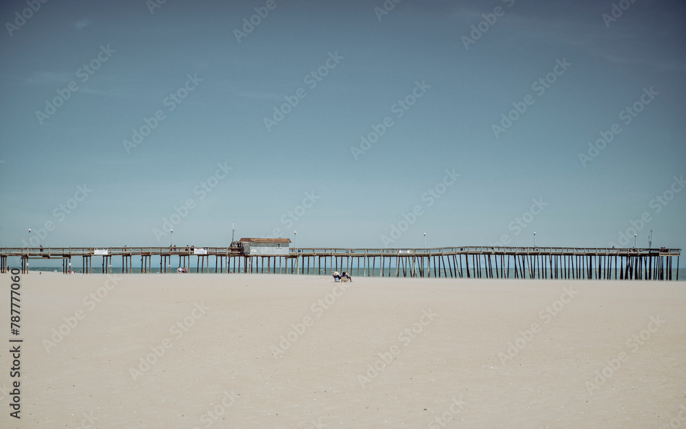 Sandy beach and calm sea with clear blue sky near Ocean City Maryland