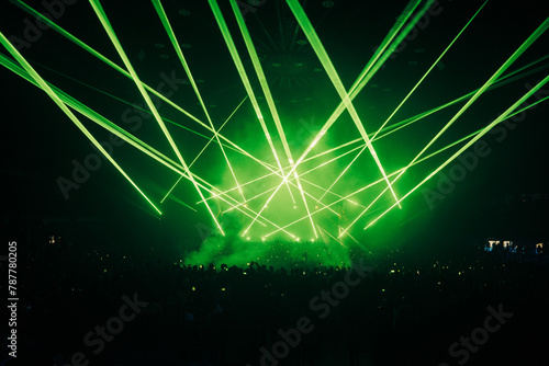 Lasers at a DJ Show, with a crowd in the foreground