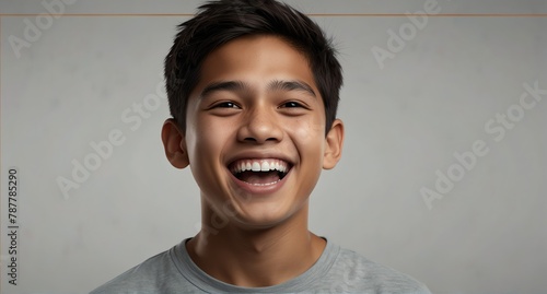 young filipino teenage boy on plain bright white background laughing hysterically looking at camera background banner template ad marketing concept from Generative AI photo