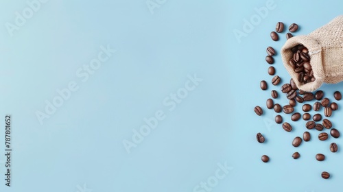   A blue backdrop features a coffee bean sack overflowing, beans cascading out, and a handful of strays surrounding it