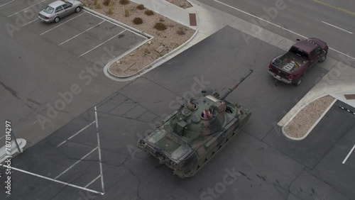 High drone shot of tank behind truck