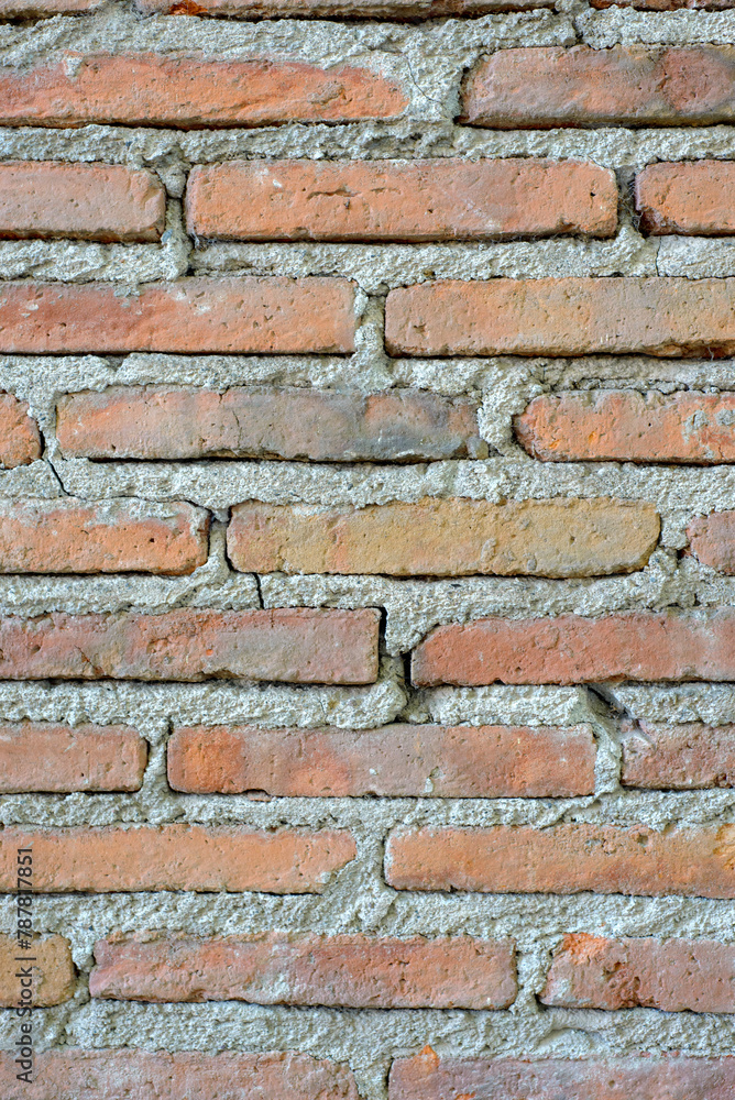 Fototapeta premium Old thin red brick wall. Textured background.