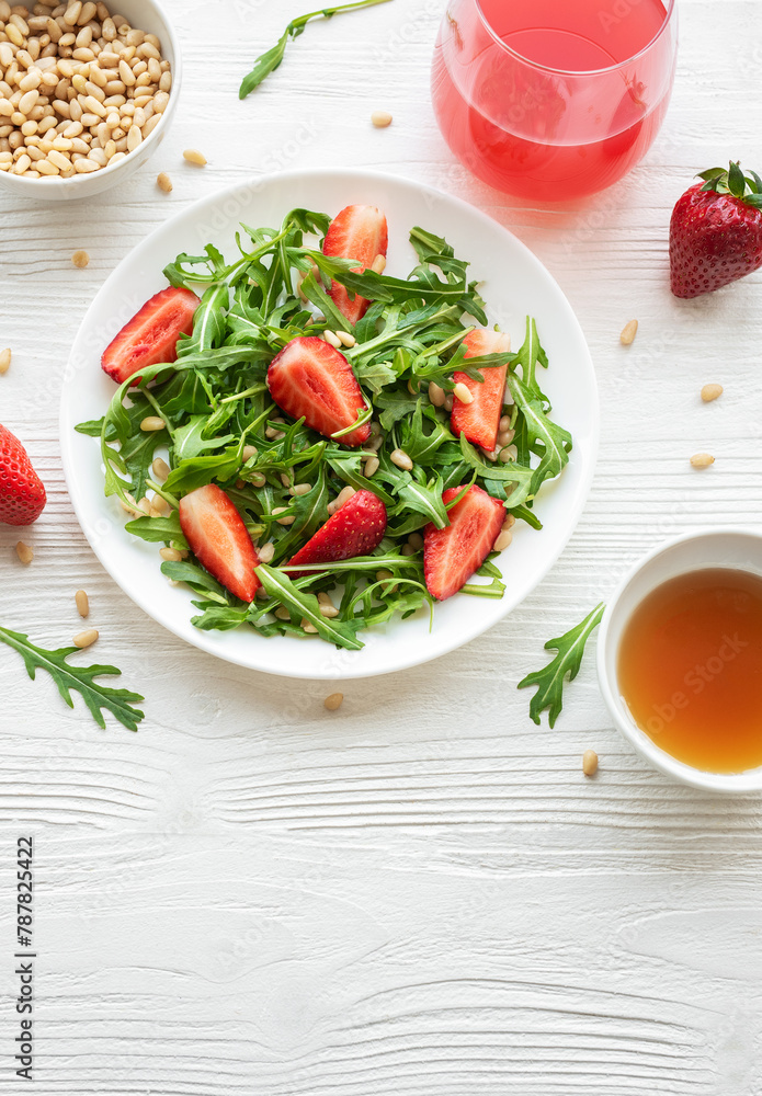 Fresh Strawberry Arugula Salad With Pine Nuts Served on a Bright Day