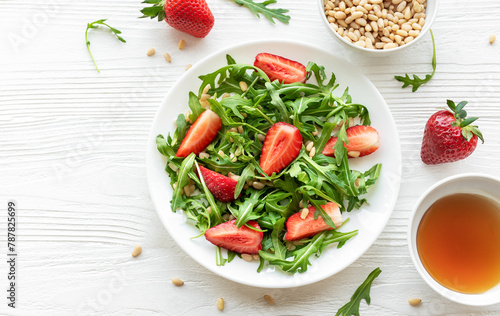 Fresh Strawberry Arugula Salad With Pine Nuts Served on a Bright Day