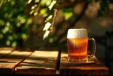 Mug of beer on a wooden table against the background of nature