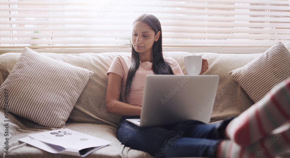Fototapeta premium Sofa, documents and woman with laptop for remote work, relax and coffee for online career. Paperwork, reading and freelancer girl in home with computer for web project, research and drink on couch.