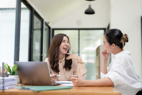 Smiling businesswoman listens attentively during a productive team meeting in a contemporary office setting.