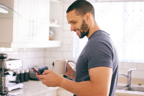 Home, coffee and man with smartphone, typing and connection with internet and latte in kitchen. Person in house, mobile user or guy with morning tea or cappuccino with cellphone, text or social media