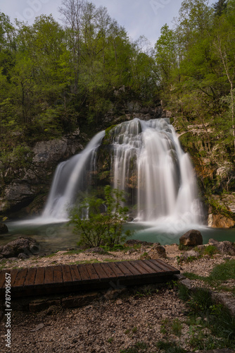 Fototapeta Naklejka Na Ścianę i Meble -  Bovec, Slovenia. Visje waterfalls. Nature trail crystal clear, turquoise water. easy trekking, nature experience, wood path. Waterfalls inside a forest, long photographic exposure, power of nature.