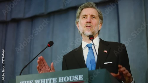 President of the United States says inspirational political speech from tribune at press campaign in conference room. Confident politician or congressman answers questions, gives interview for media.