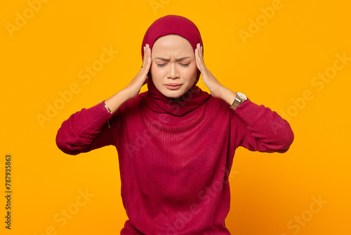 Beautiful Asian woman holding her temples, having a headache, wi © Bangun Stock Photo