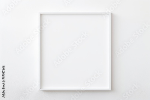 A white picture frame hangs gracefully on a wall, adding a touch of elegance to the space