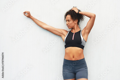 Athlete, girl and outdoor with sportswear, wall and break from workout, practice and training of body. Exercise, healthy and strong with muscle, wellness and energy for sports, active and weekend © peopleimages.com