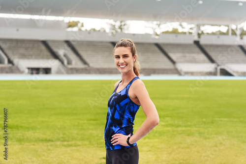 Girl, athlete and happy portrait in stadium for long distance running or sprinting for athletics and training. Female runner, confident and positive for track or field events for olympics in Paris. © peopleimages.com