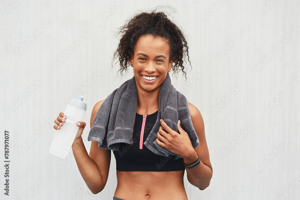 Obraz premium Black woman, athlete and water bottle in studio, portrait and hydrate after workout on white background. Female person, detox and mineral liquid for recovery after exercise, fitness and mockup space