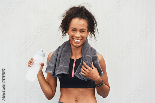 Black woman, athlete and water bottle in studio, portrait and hydrate after workout on white background. Female person, detox and mineral liquid for recovery after exercise, fitness and mockup space © peopleimages.com