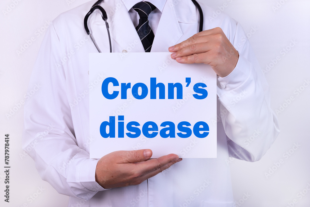 Doctor holding a card with Crohn's disease medical concept Doctor holding a card with Crohn's disease medical concept
