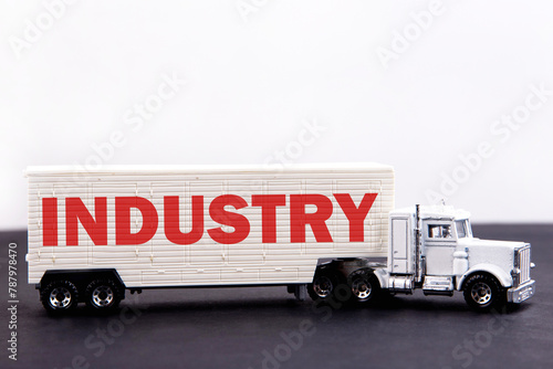 Industry word concept written on board a lorry trailer on a dark table and light background photo