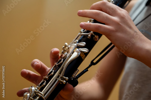 Close up of children's hands playing the clarinet in a music studio