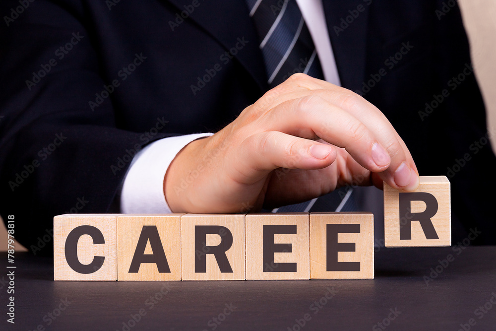 Obraz premium Man made word Career with wooden blocks. Business concept.