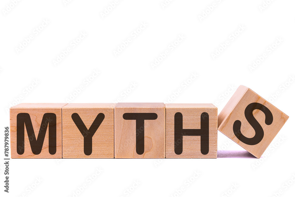 Word MYTHS is made of wooden building blocks lying on the table and on a light background. Concept. Word MYTHS is made of wooden building blocks lying on the table and on a light background. Concept.