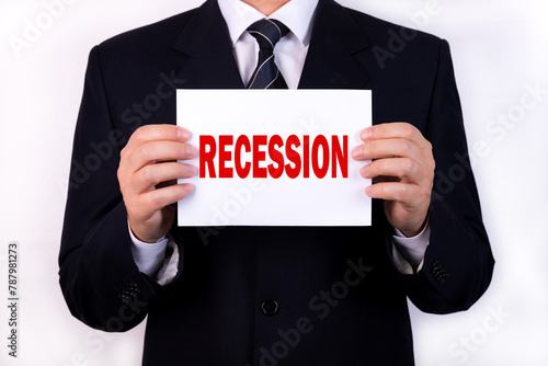 Text, the word Recession, written on a tablet held by a businessman. Business concept. photo