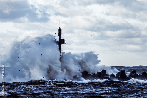 Storm waves crashing against the breakwater at port of Klaipeda, Lithuania photo