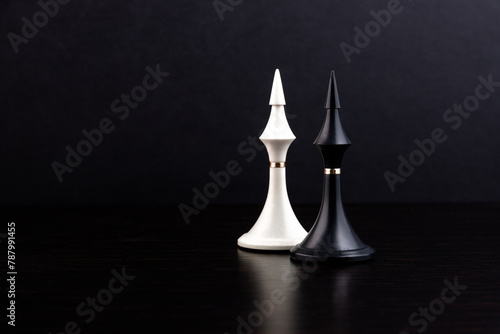 White and black chess pieces on a chessboard on a dark background. Business concept. Game, strategy, wisdom, determination.