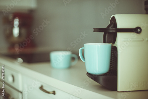 Close-up of a coffee machine and mugs on a kitchen counter photo