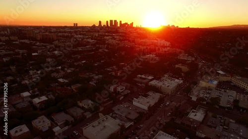 Aerial Forward Shot Of City With Back Lit Downtown Buildings At Sunset - West Hollywood, California photo