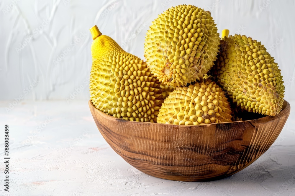Beautifully arranged ripe jackfruit in wooden bowl on white background Beautifully arranged ripe jackfruit in wooden bowl on white background