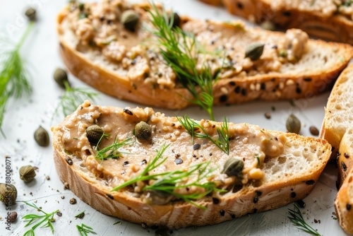 Bread with pate capers and dill on table