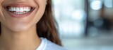 woman smiling with white teeth close up in a dental clinic background with a banner for a healthy smile and clean teeth concept. Copy space for a text banner stock photo concept.