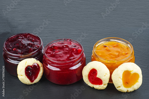 Three colored jam in glass jare with cookies shaped hearts